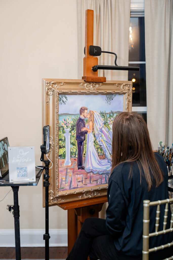 Live wedding painter painting bride and groom during ceremony