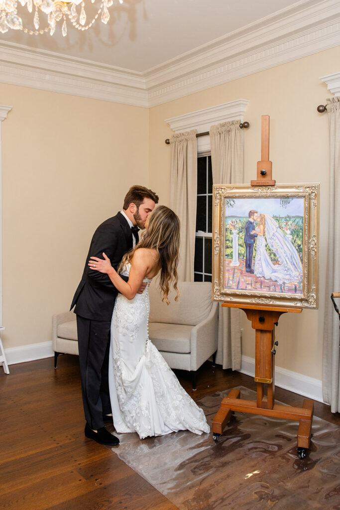 Bride and groom recreating the first kiss captured by their live wedding painter