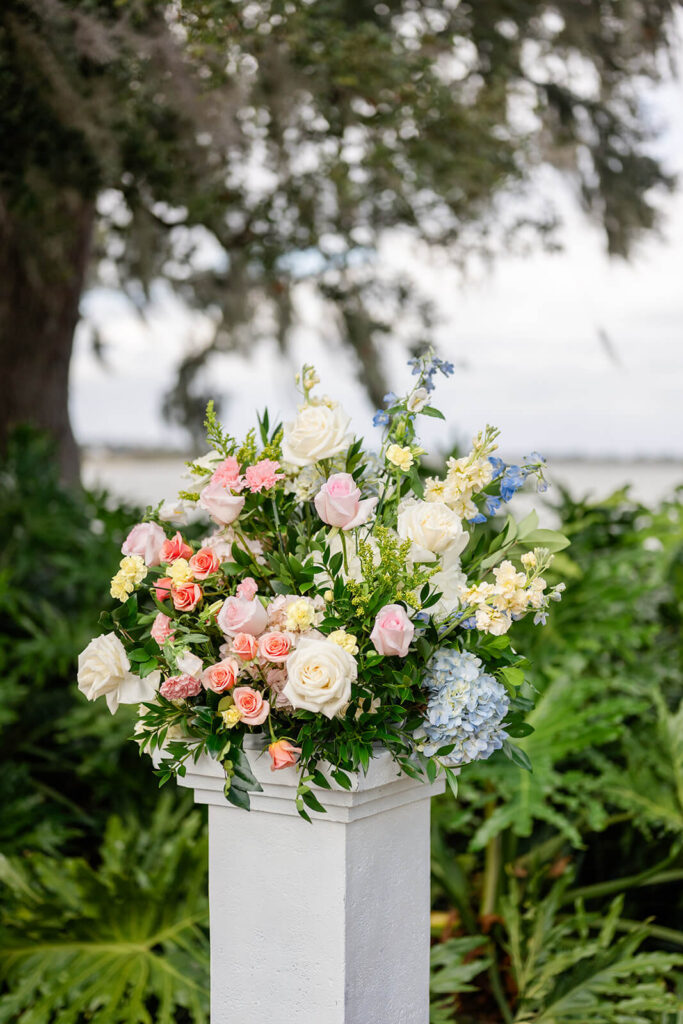 Pastel floral arrangement on a white column