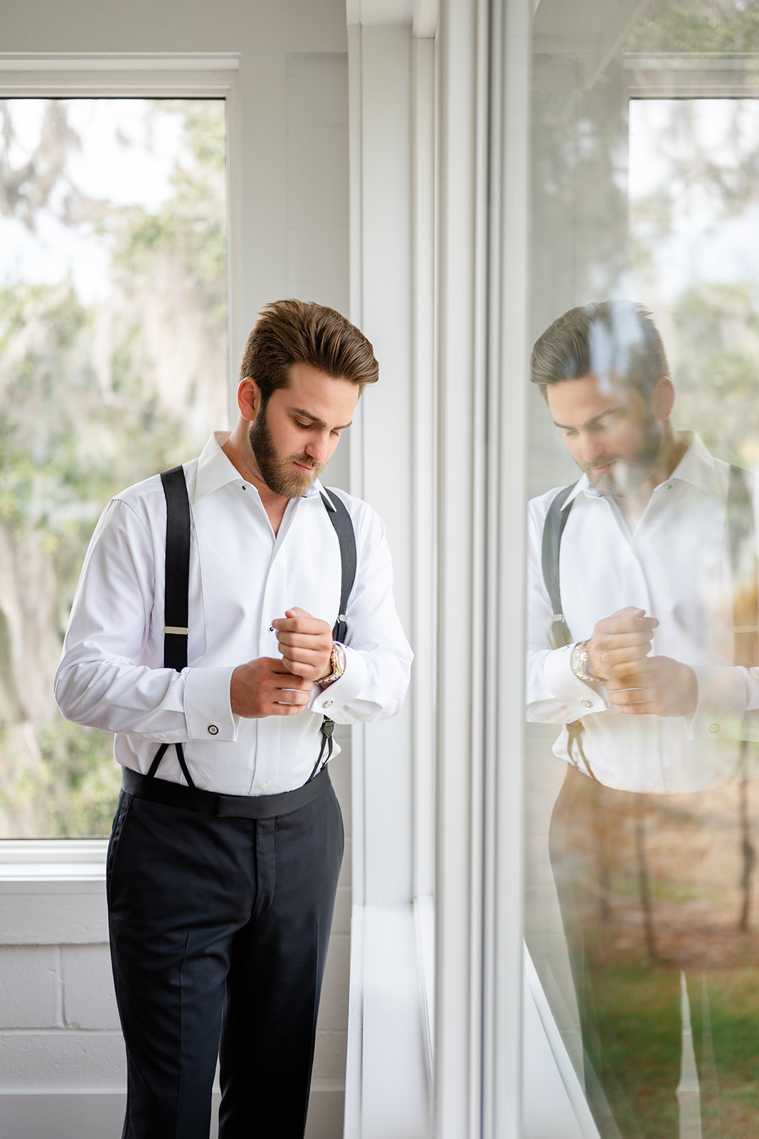 Groom adjusting cufflinks