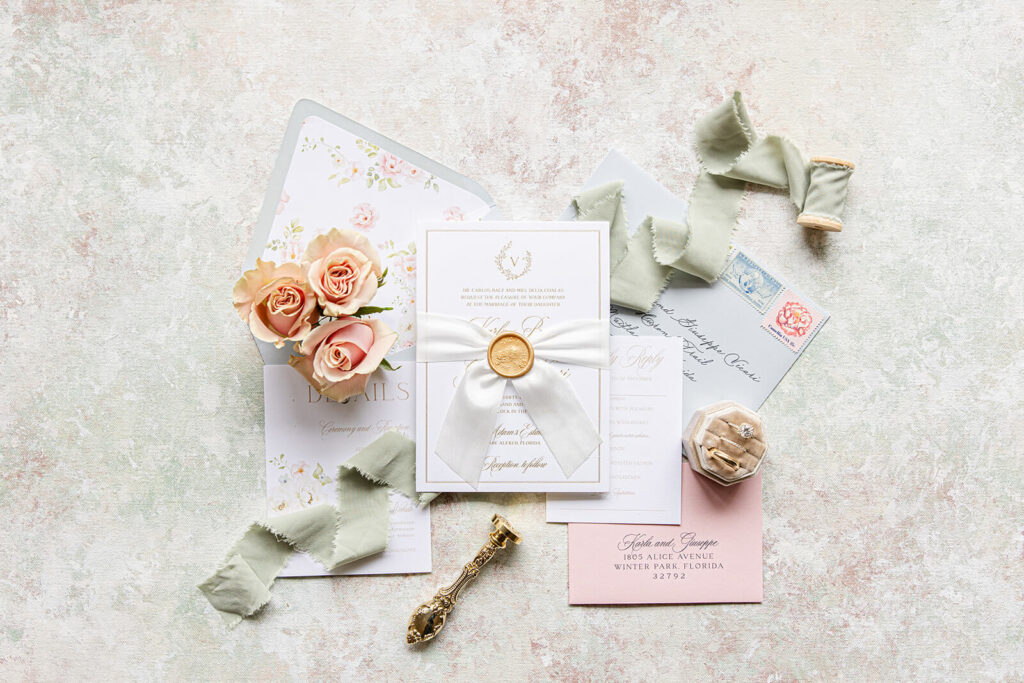 Romantic custom wedding invitations with gold foil press, custom monogram, gold wax seal, and silk ribbon