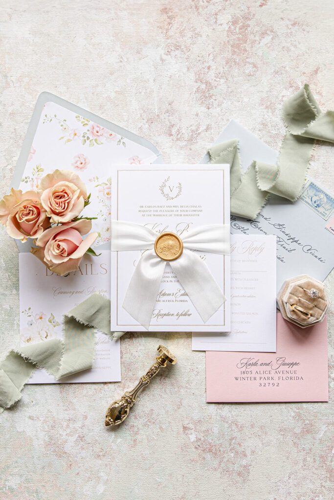 Romantic custom wedding invitation suite with gold foil press, custom monogram, and floral details