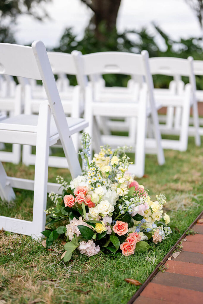 Pastel floral arrangement lining the aisle
