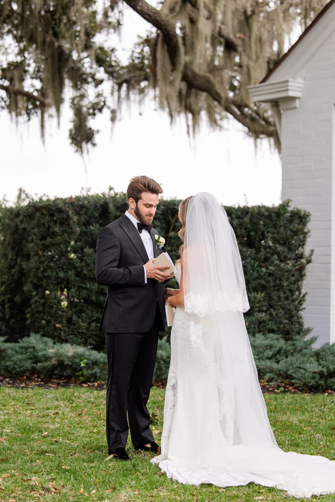 Bride and groom private vow reading outside Adams Estate on their wedding day