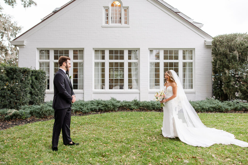 Groom turning around to see his bride for the first time on their wedding day at Adams Estate
