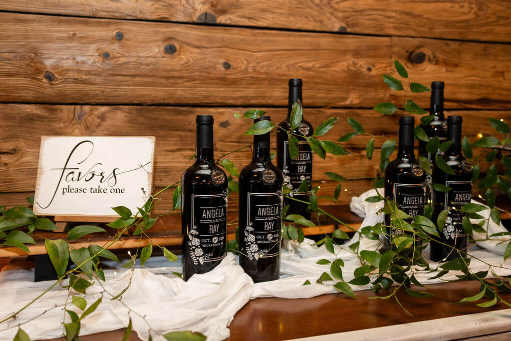 Wedding guest favors: wine bottles with wedding day information on a sticker