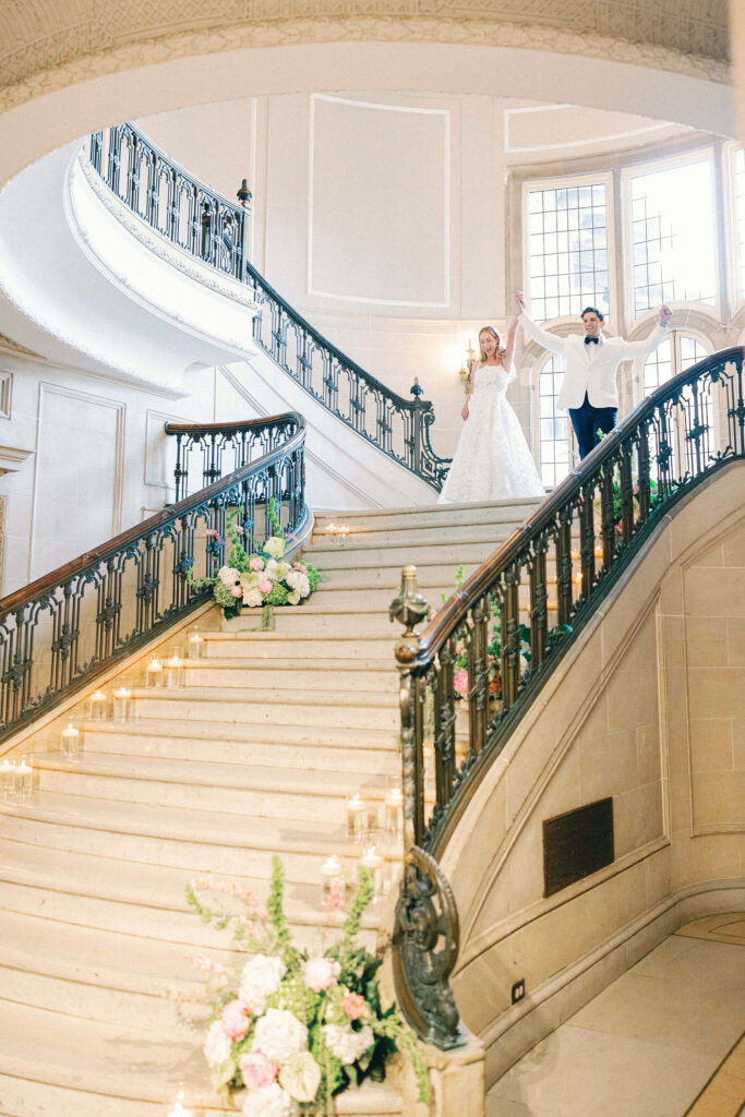 Bride and groom enter the wedding reception via the grand staircase