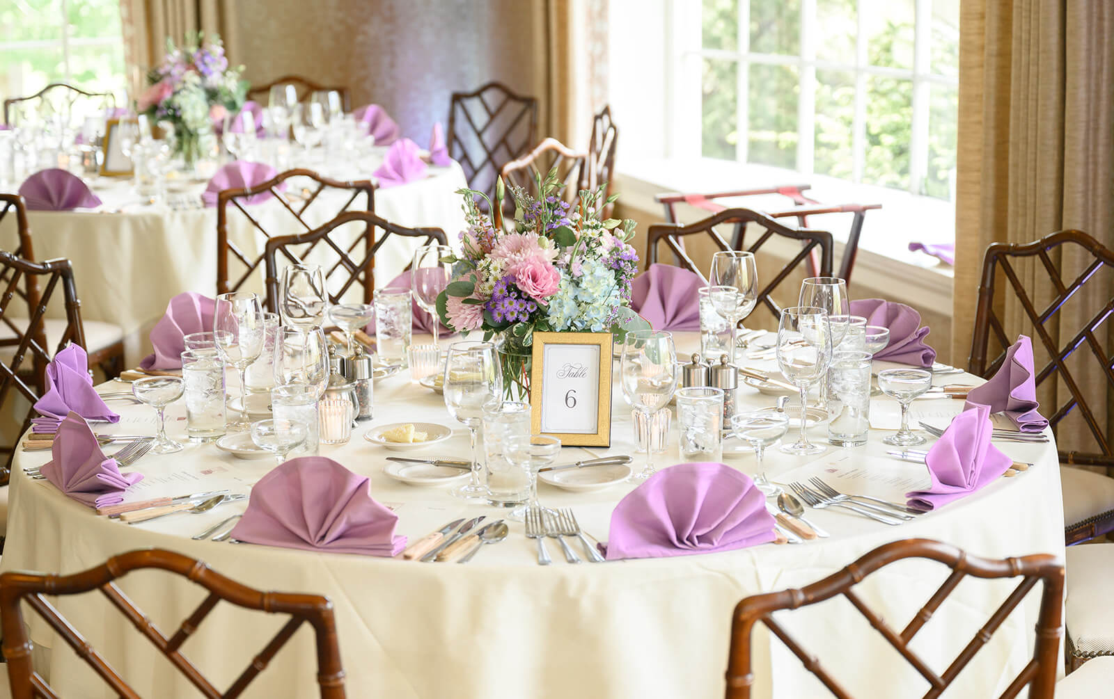 Elegant purple and cream wedding reception table at the Kimberton Inn