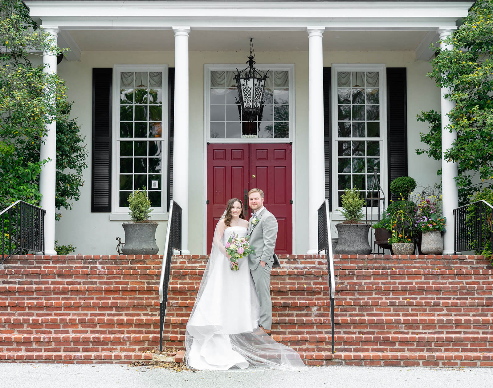 Bride and groom on the steps of the Kimberton Inn on their wedding day
