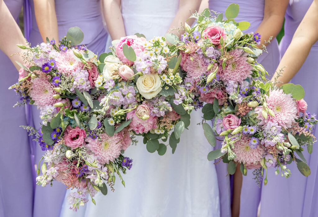 Pastel bridal bouquets in shades of pink, purple, and blue